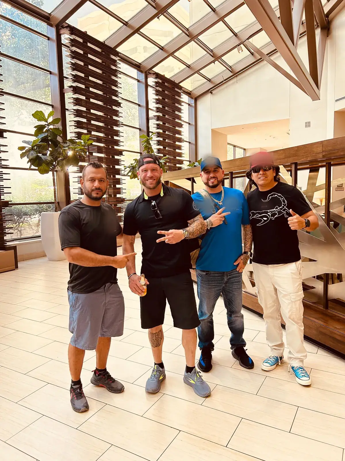 Four Champion Moving crew members standing together in a building lobby