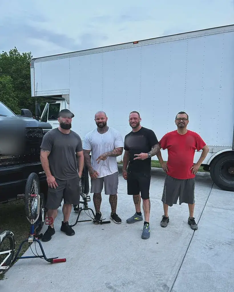 Four Champion Moving crew members standing in front of a box truck