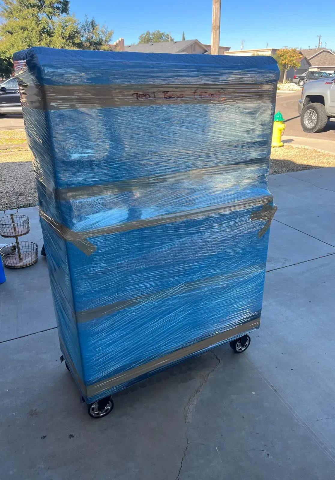 Rolling dresser stretch-wrapped in plastic and ready to load